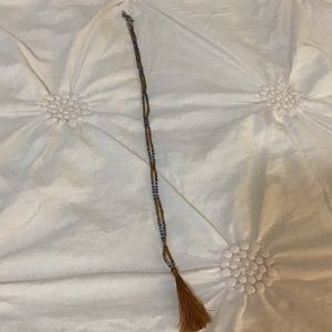 It is a necklace it is brown,clear and blue Little beads